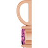 Close-up of a rose gold pendant setting with a faceted pink gemstone, shown against a plain white background.