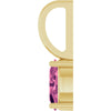 A close-up of a yellow gold pendant setting with a faceted pink tourmaline gemstone, shown against a plain white background.