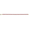 A gold tennis bracelet featuring a row of small oval-cut deep red ruby gemstones, displayed horizontally against a solid white background.