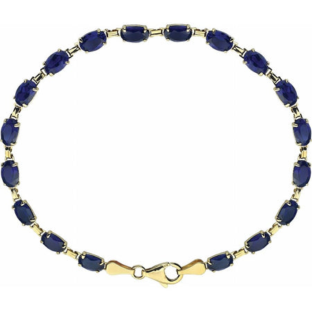 A yellow gold tennis bracelet featuring oval-cut dark blue gemstones, arranged in a circular shape on a plain white background.