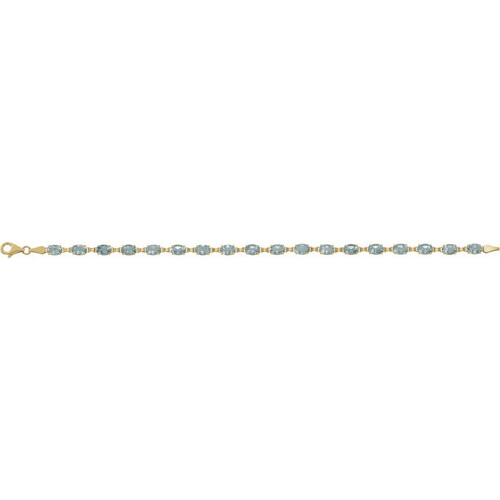 A yellow gold tennis bracelet featuring a row of oval-cut light blue topaz gemstones, displayed horizontally against a solid white background.