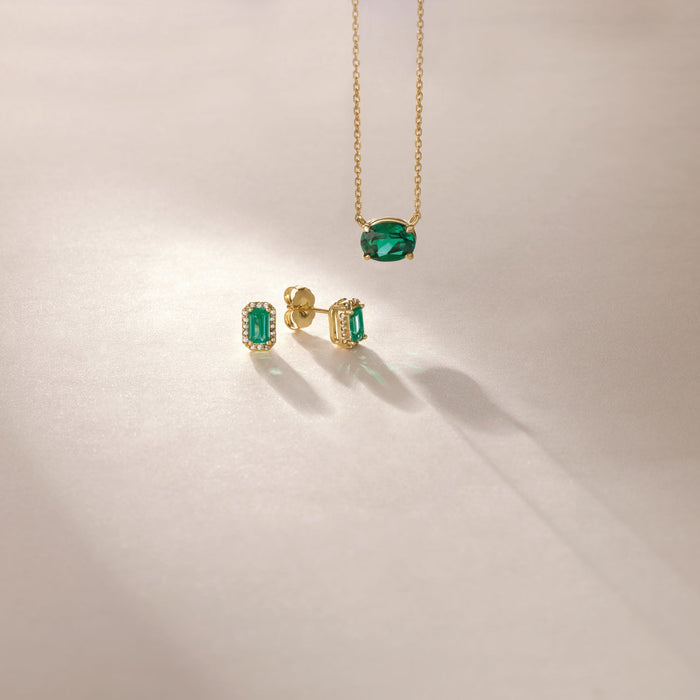 Emerald pendant gold necklace with emerald diamond halo stud earrings 