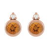 A pair of rose gold stud earrings featuring a round faceted citrine center stone and a round diamond at the top, set in a polished rose gold bezel.