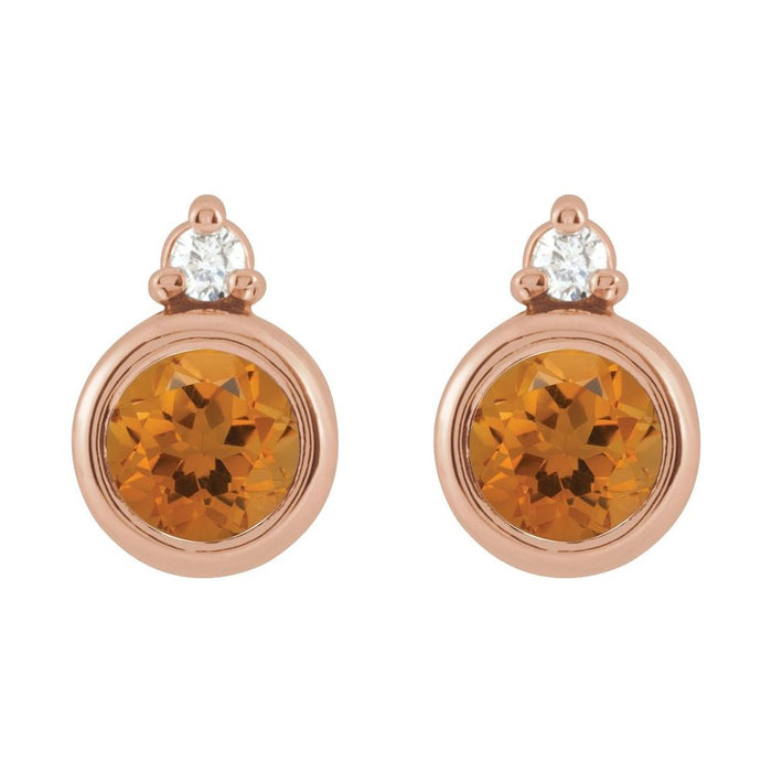 A pair of rose gold stud earrings featuring a round faceted citrine center stone and a round diamond at the top, set in a polished rose gold bezel.