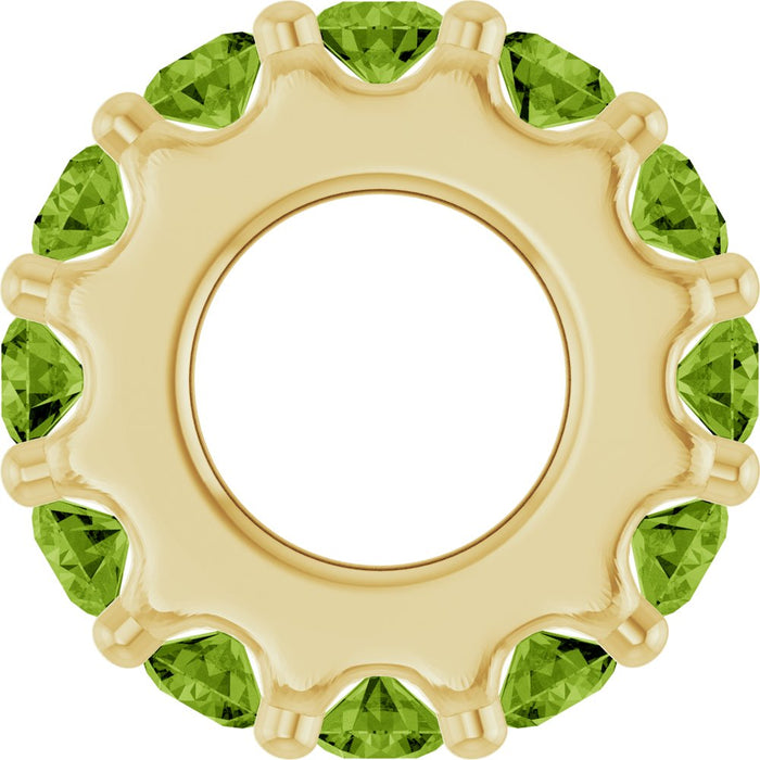 Gold charm with light green gemstones on a white background