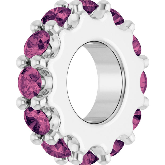 White gold charm with pink gemstones on a white background