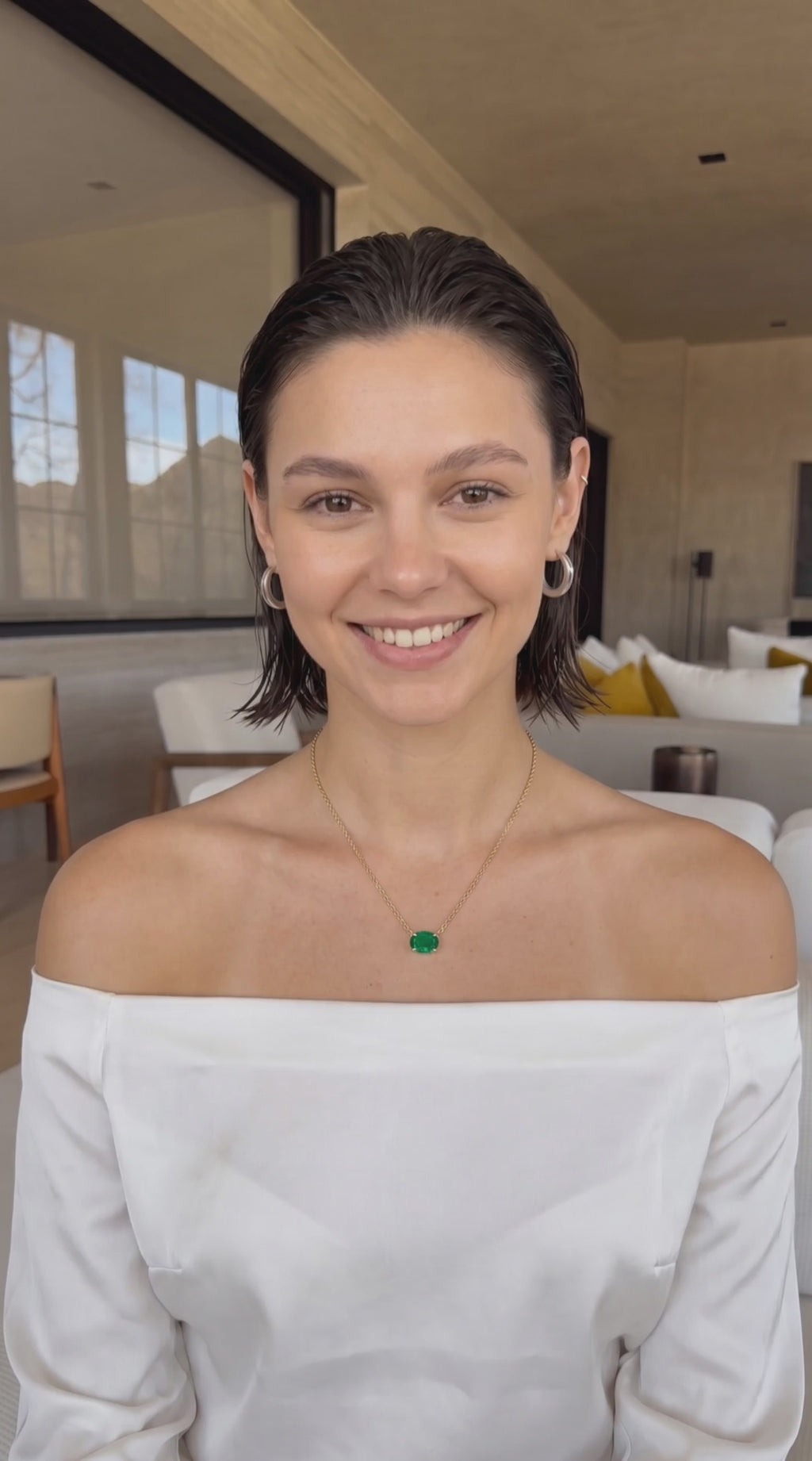Video of woman talking about her oval emerald gold necklace