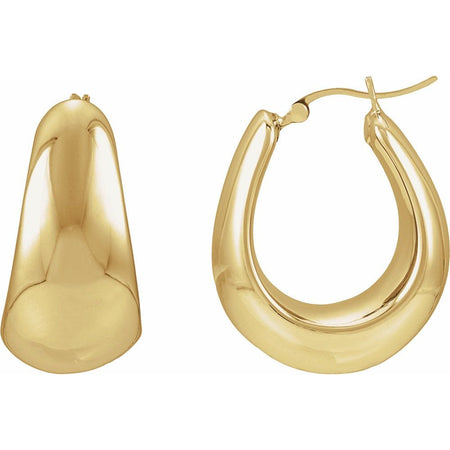 Puffed gold hoop earrings on a white background
