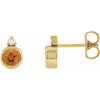 Yellow gold earring with a round citrine gemstone on a white background