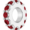 White gold charm with red gemstones on a white background
