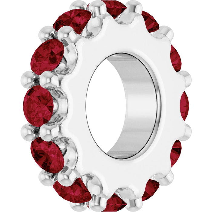 White gold charm with red gemstones on a white background