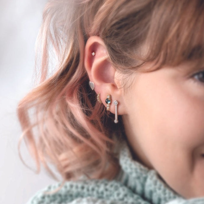 Model wearing Heart Earring as part of a curated ear 