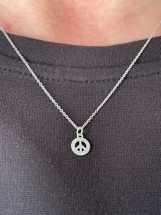 Model wearing Keep the Peace Diamond Peace Sign Necklace 14K White Gold