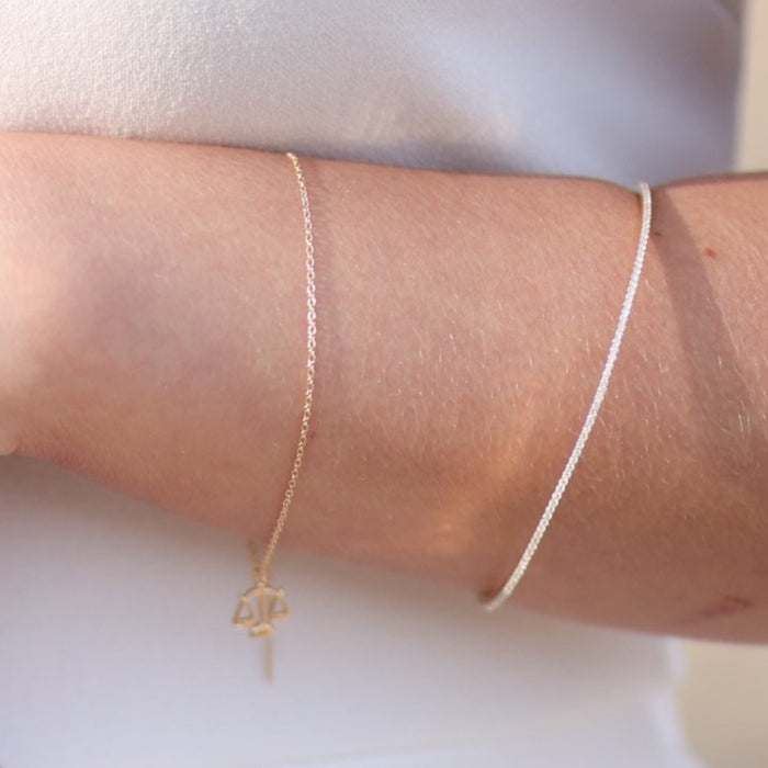 Model wearing our 1 CTW Diamond Bangle and our Threader Bracelet with Zodiac Charm