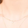 Model wearing diamond micro bezel-set 18" necklace in 14K yellow gold Storyteller by Vintage Magnality