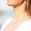 Model wearing freshwater cultured pearl and bead station 18" necklace in 14K Yellow gold  Storyteller by Vintage Magnality