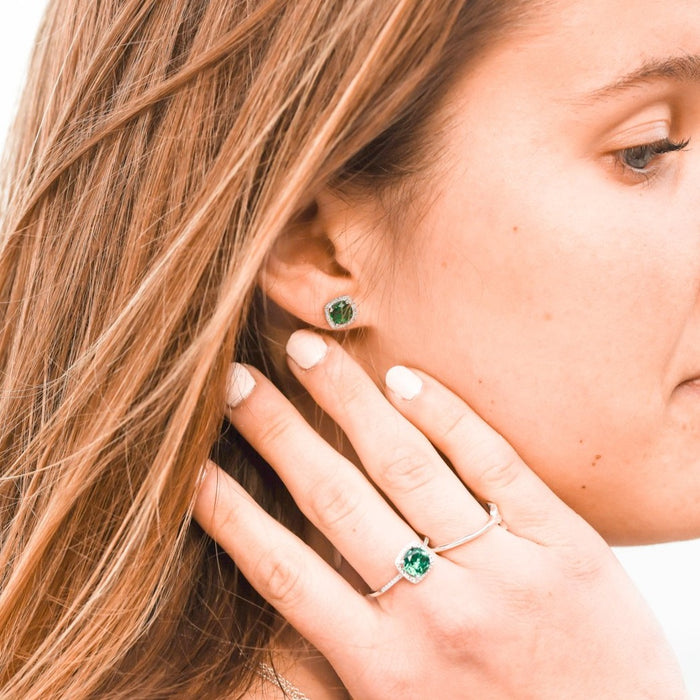 Model wearing emerald and diamond ring and earrings Storyteller by Vintage Magnality