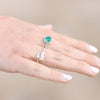 Model wearing arrow ring next to emerald and diamond ring Storyteller by Vintage Magnality