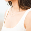 Model wearing Natural Diamond Lowercase Initial Necklace in 14K Yellow Gold