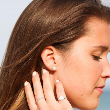 Model wearing Statement Birthstone Pearl and Natural Diamond Halo Sterling Silver Earrings