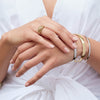 Model wearing Wear Everyday™ Bold Chunky Ring and Half Round Bangle Bracelets Stacked in White and Yellow Gold