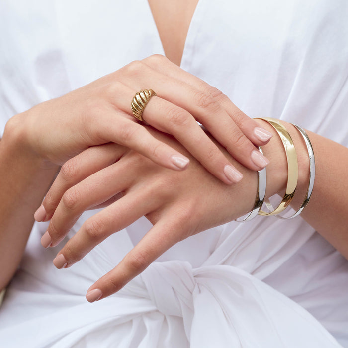 Model wearing Wear Everyday™ Bold Chunky Ring and Half Round Bangle Bracelets Stacked in White and Yellow Gold