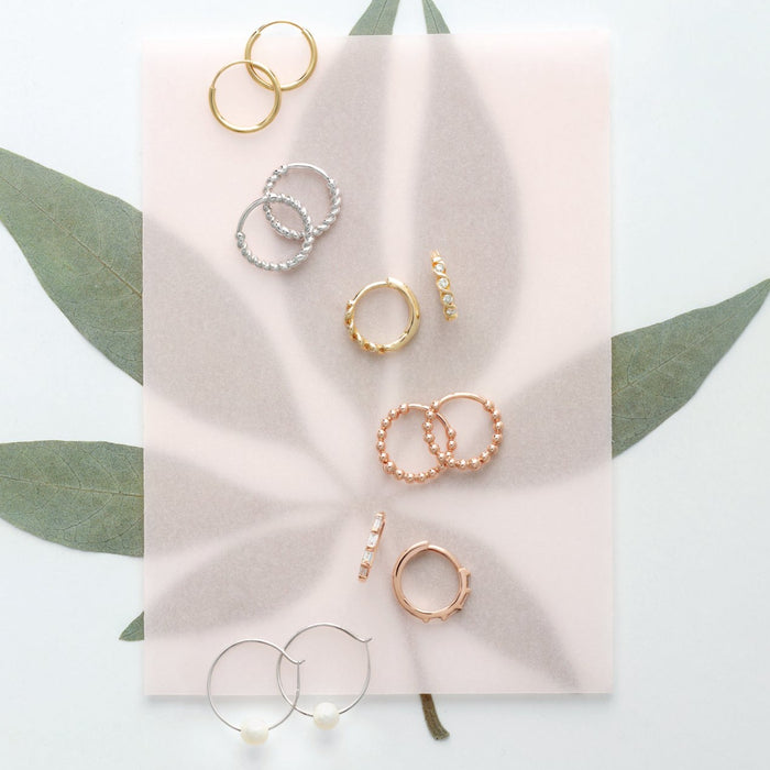 A collection of solid 14K gold hoop earrings