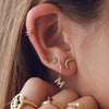 Model wearing Baguette Bezel-Set Gemstone Earring in 14K Yellow Gold as Part of a Curated Ear