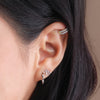 Model's curated ear with Zodiac Stud Earring, Diamond Ear Cuff and Spike Hoop Earring