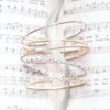 14K Gold and Diamond Bangle Bracelets Shown in a Stack