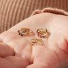 Hinged Hoop Huggie Earrings in 14K Yellow Gold in Blue Sapphire Ruby and Diamond Styles in Model's Hand