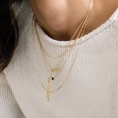 Mama Natural Diamond Necklace in 14K Yellow Gold Layered with Other Necklaces on Model