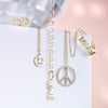 Tiny Peace Sign Stud Earrings Shown with other Peace and Love Fine Jewelry Pieces