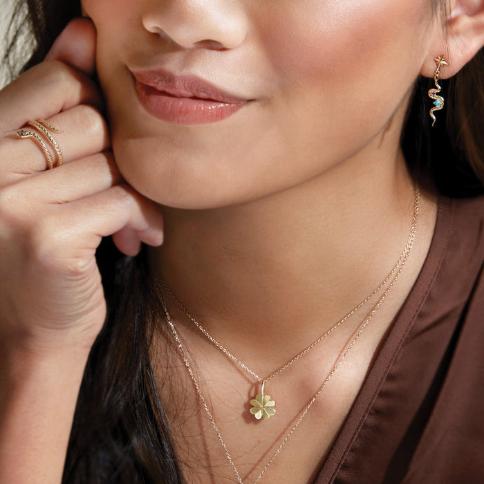 Model Wearing our Garnet Spiral Ring with Dangle Serpent Turquoise Ruby Earring and Clover Charm Necklace