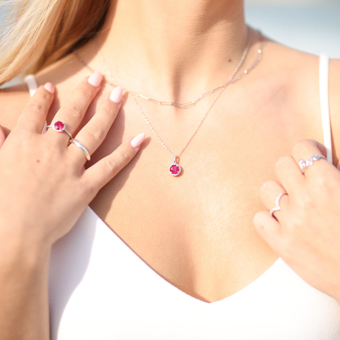 Model wearing our Round Statement Birthstone Ruby & Diamond Halo Style Ring in Sterling Silver