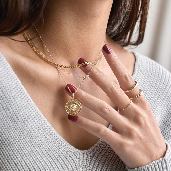 Model wearing 14K Gold jewelry including our Petite Dome Wear Everyday™ Ring