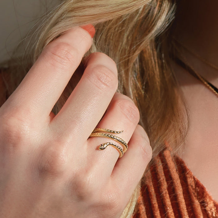 Model wearing our Solid 14K Yellow Gold Garnet Snake Spiral Ring