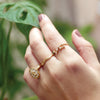 Mode Wearing Miraculous Medal White Enamel Solid 14K Yellow Gold Ring with Zodiac Diamond Ring Next To Plant