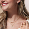 Model wearing Sun Disc Starburst Necklace in Yellow Gold 