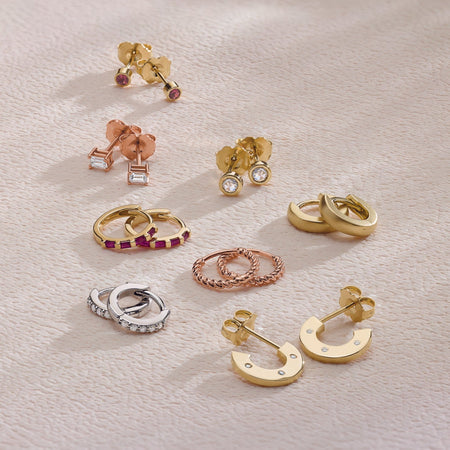 A collection of 14K Solid Gold Hoop and Stud Earrings