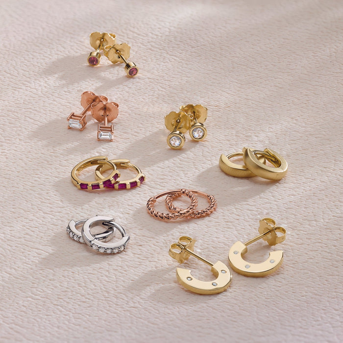 A collection of 14K Solid Gold Hoop and Stud Earrings